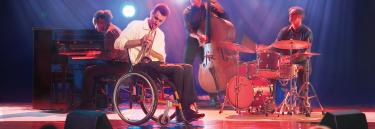 inspirational|XLT08 BE02.jpg|XLT Active & Dynamic orange frame man playing instrument on stage