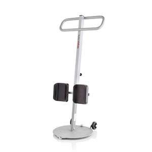 White stand-and-turn transfer aid with upright support handle, dual knee pads, and a round base with integrated caster wheels for assisted patient movement.