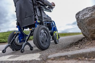 Invacare Esprit Action power wheelchair driving up a slope